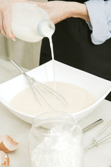 Fototapeta na wymiar cook pouring milk preparing desserts