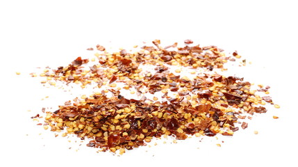 pile crushed red pepper, dried chili flakes and seeds isolated on white background