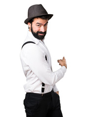 Hipster man with beard pointing back