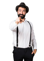 Hipster man with beard pointing to the front