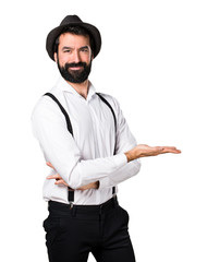 Hipster man with beard presenting something