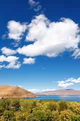 Sevan lake and white clouds blue sky on a sunny day, Armenia