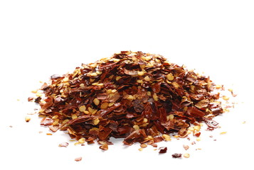 pile crushed red pepper, dried chili flakes and seeds isolated on white background