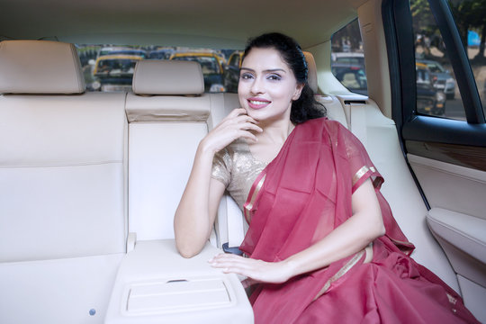 Indian woman with saree clothes in car