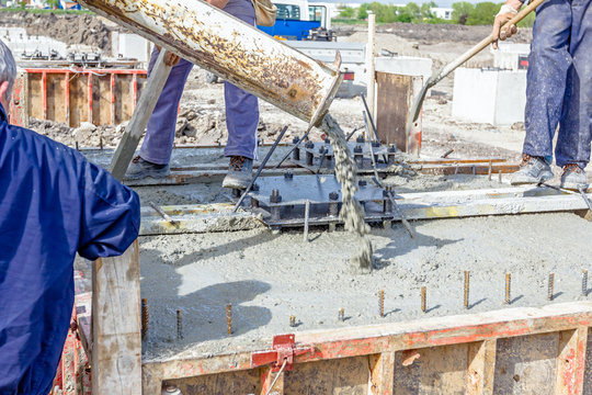 Pouring reinforced concrete in foundation mold