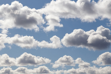 Fluffy clouds under the blue sky float