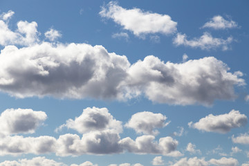 Fototapeta na wymiar Fluffy clouds under the blue sky float