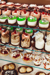 rows of italian mignon cakes on a glass stand
