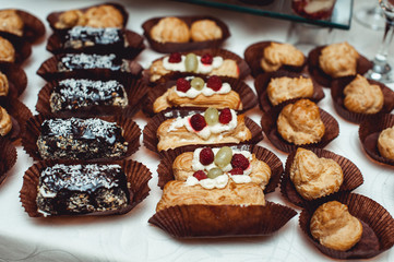 eclairs, traditional french dessert. white table