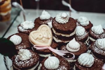 Sandwich cookies of brown color. Lots of biscuits with custard. Pastry with vanilla filling.