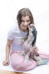 Dog licks a girl against a white background 