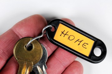 Closeup photo of hand holding keys with word Home. - 141966065