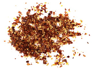 pile crushed red pepper, dried chili flakes and seeds isolated on white background, top view
