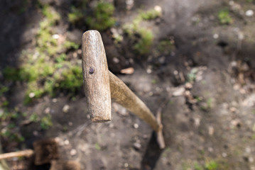 Shovel in the ground, depth of focus on purpose placed on the handle of the shovel