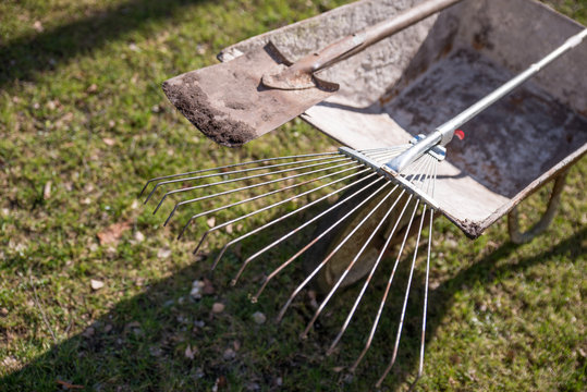 wheelbarrow with shovel and rake