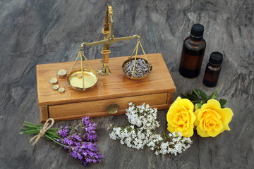 Natural Alternative Medicine. With aromatherapy essential oil, flowers and old brass scales.