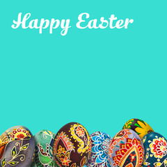 Easter eggs over blue background. View with copy space