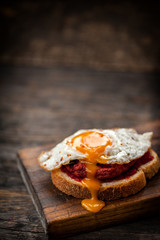 Vegetarian beetroot sandwich with egg, spinach and red chili jam