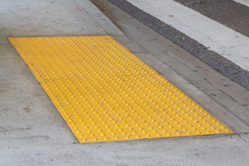 Tactile paving with textured ground surface with markings, indicators for blind
