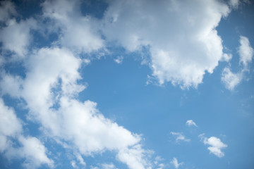 White heap clouds in the blue sky at the summer day.