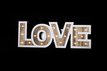 Love word letters in lights. Wooden letters with lights inside.