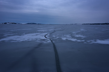 Frozen Lake. Beautiful stratus clouds over the ice surface on a frosty day. Natural background