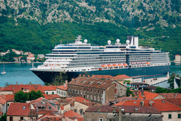 Fototapeta na wymiar Liner on the dock in Kotor, near the Old Town in Bay of Kotor, Montenegro. The view from the observation deck over the city.