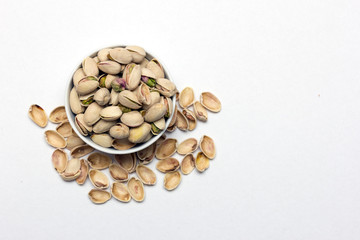 A shot from top, pistachios on white background.