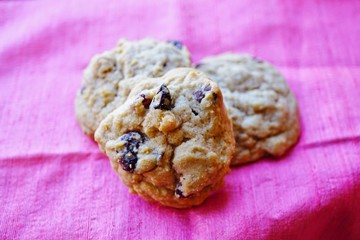 Homemade raisin cookies on a pink background