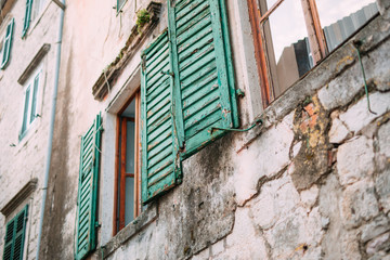 Fototapeta na wymiar Green window shutters. The facade of houses in Montenegro.