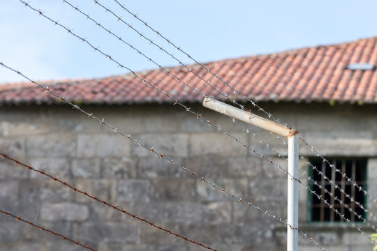 barbed wire in front of the prison building