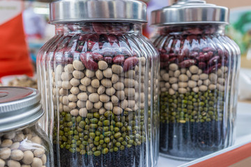 beans and peas, green, red and black sesame protein in the jars