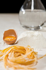 Closeup of Italian tagliatelle pasta and its ingredients