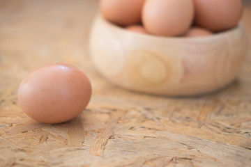 Chicken eggs in the wooden bowl