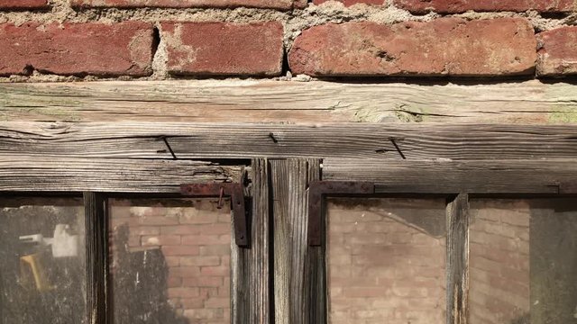 Destructed building facade with broken glass and wooden opening 4K 2160p 30fps UltraHD footage - Old house weathered window and walls 3840X2160 UHD video 