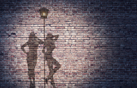 shadow of two prostitutes on the brick wall