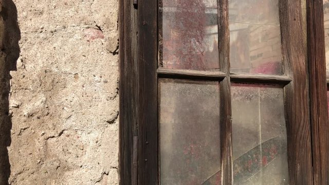 Old house weathered window and walls 4K 2160p 30fps UltraHD footage - Destructed building facade with broken glass and wooden opening 3840X2160 UHD video 
