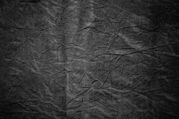 Texture of dark grey crumpled fabric