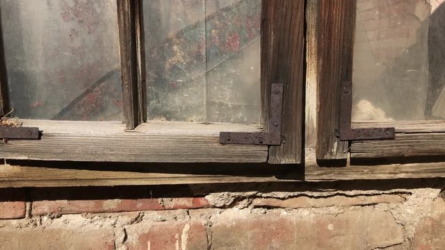 Detailed house weathered window and walls 4K 2160p 30fps UltraHD footage - Destructed building facade with broken glass and wooden opening 3840X2160 UHD video
