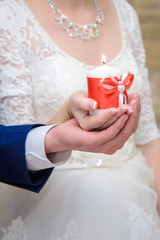 The bride and groom holding a candle
