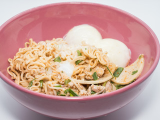 Instant noodle food with eggs in a cup on white background