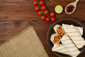 Burritos wraps with meat, beans and vegetables. © gkrphoto