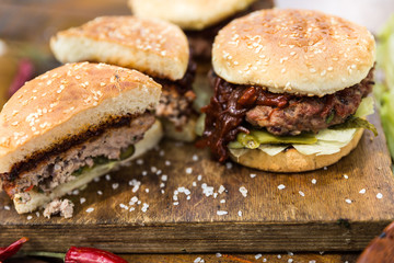 Grilled burgers on cutting board
