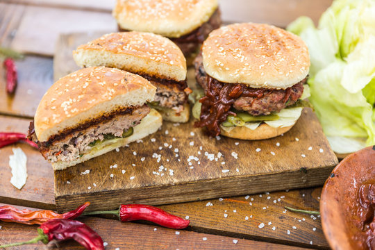 Grilled burgers on wooden cutting board