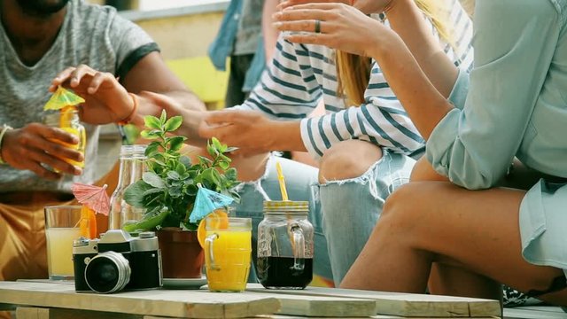 View of table full of colorful cocktails at rooftop party, graded