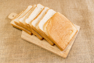 Freshly baked delicious bread on a rustic wooden background with copy space, flat lay..