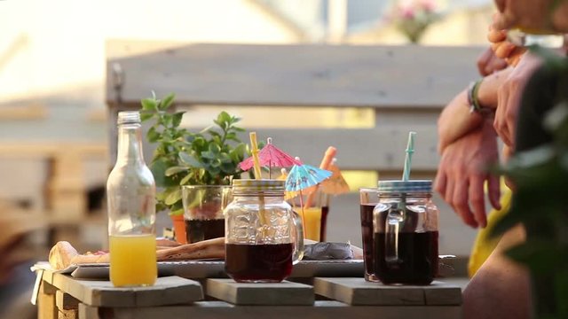 View of table with full of colorful cocktails and pizza, fast forward