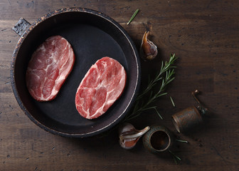Pork steak with rosemary, garlic and pepper , top view