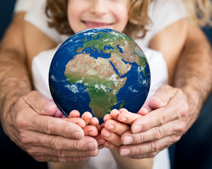 Family holding Earth planet in hands