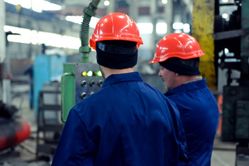 Men at the factory in helmets metallurgy